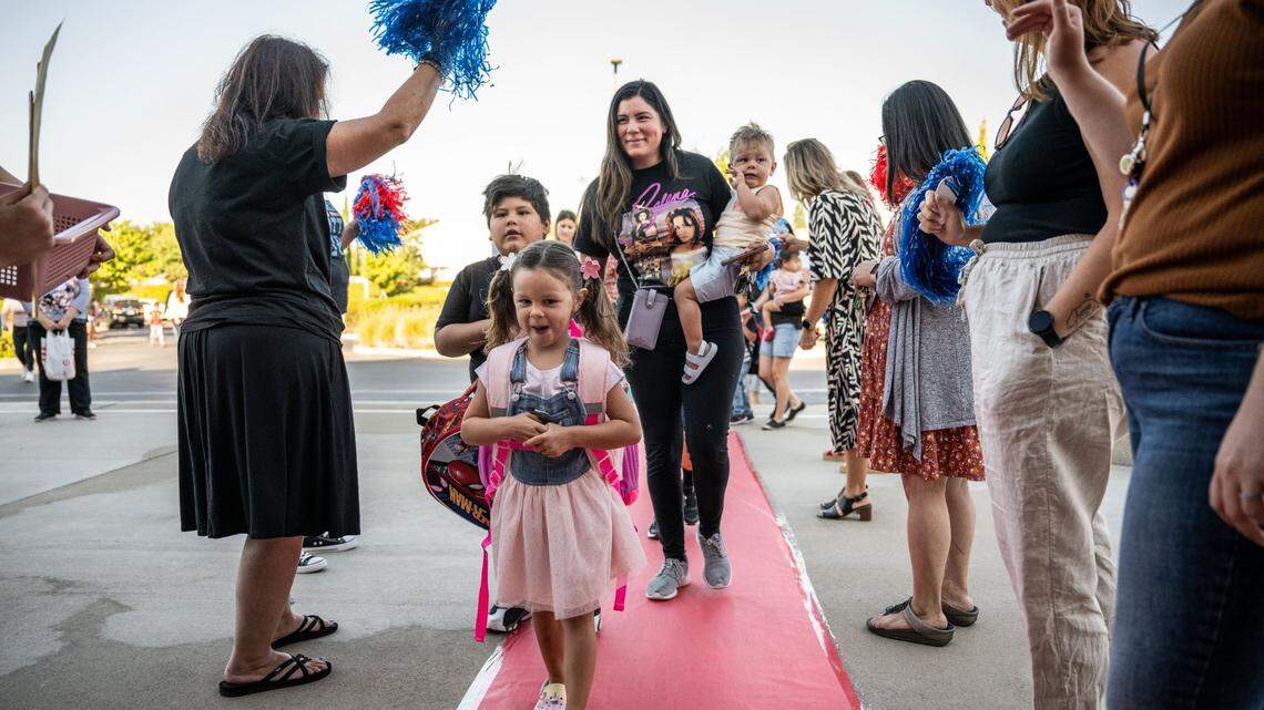 Velina Siewell, 4, a student at Navigator Elementary School in Rancho Cordova, leads her brothers Michael Barajas, 6, and Jaxon Siewell, 1, and mother Trina Barajas as they arrive Tuesday, Aug. 8, 2023, for the first day of school in the Folsom Cordova Unified School District. Schools are trying to lure students back to school in the face of high rates of chronic absenteeism.