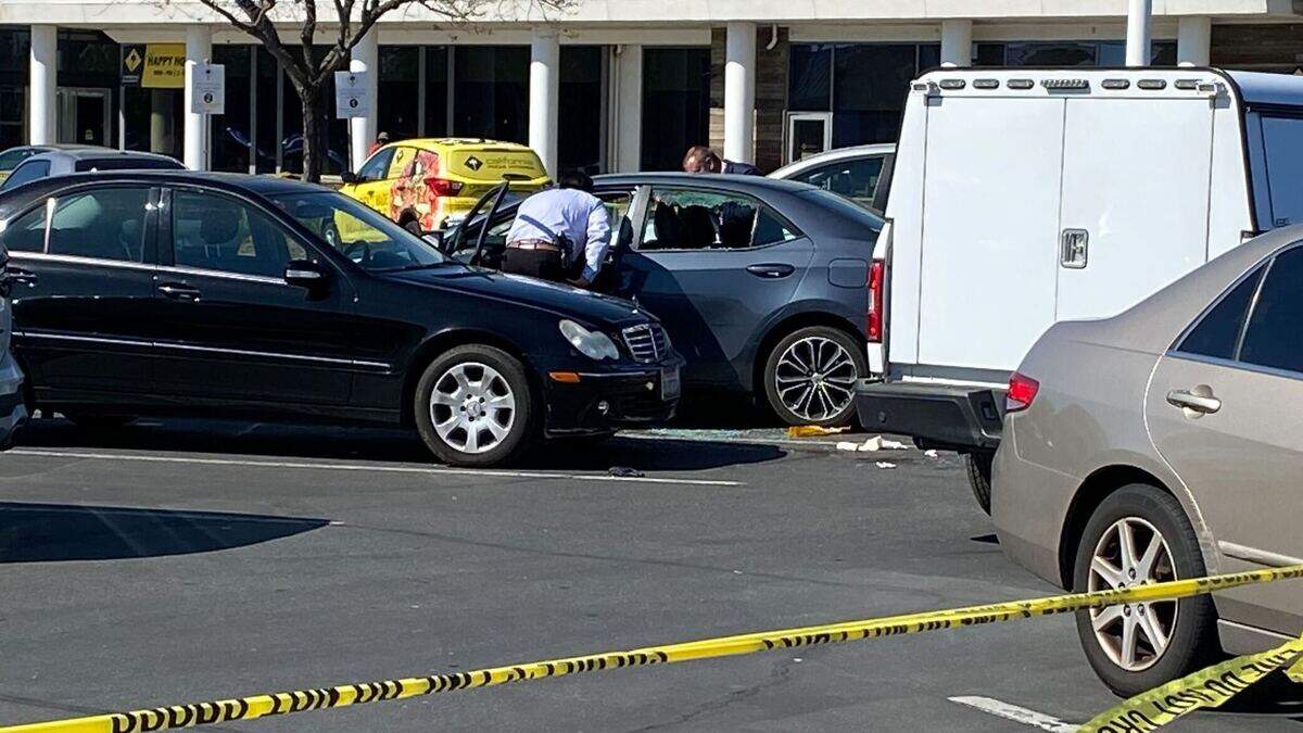 Law enforcement officials survey a vehicle in the parking lot of the AT&T store near Arden Fair mall on Thursday. The suspect in a Wednesday double homicide in Arden Arcade, identified as 32-year-old Ricky Hunter, reportedly shot himself inside his vehicle near the mall and was taken to a hospital.