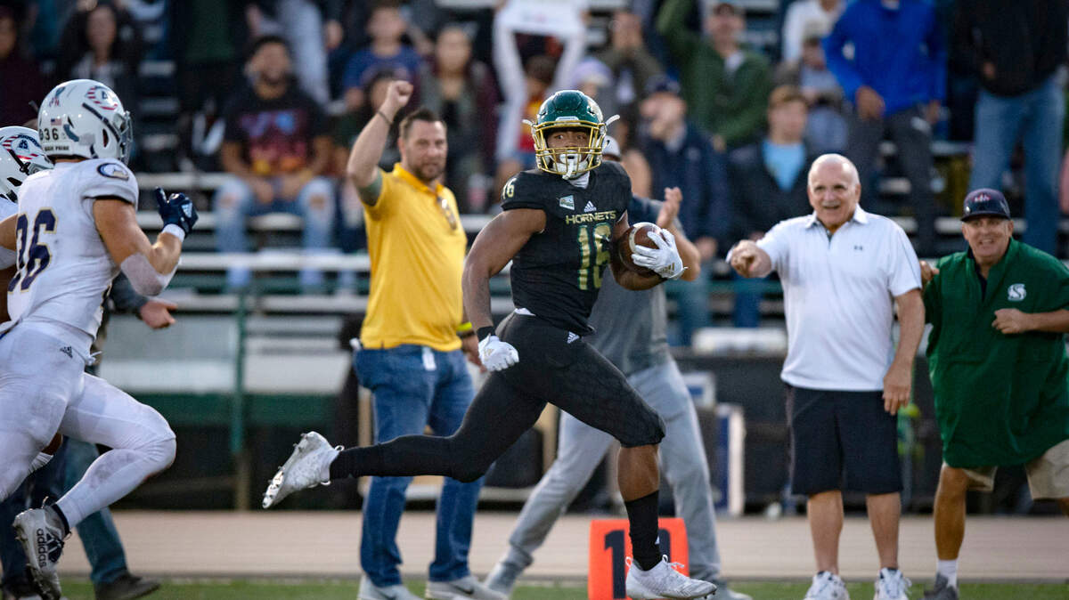 Sacramento State tight end Marshel Martin (16) runs down the sidelines while escaping several tackles before scoring a touchdown at Hornet Stadium on Saturday, Nov. 23, 2019, during the 66th Causeway Classic.