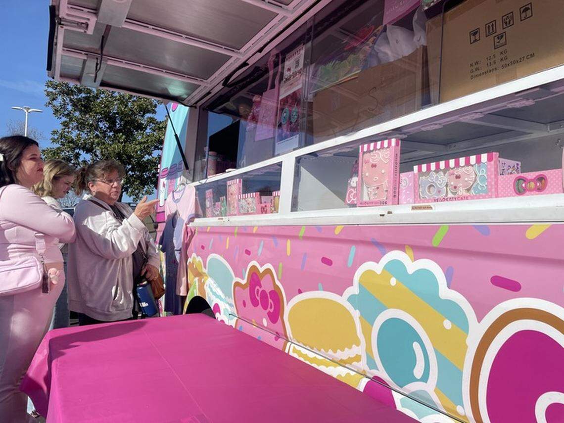 Hello Kitty fans pick out their desired merchandise and snacks from the Hello Kitty Cafe pop-up truck at Arden Fair mall in Sacramento on Saturday, Jan. 4, 2025.