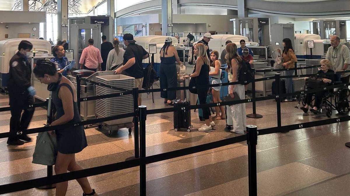 Travelers pass through the Terminal B security checkpoint at Sacramento International Airport on Tuesday. The TSA no longer requires that travelers here remove their shoes.