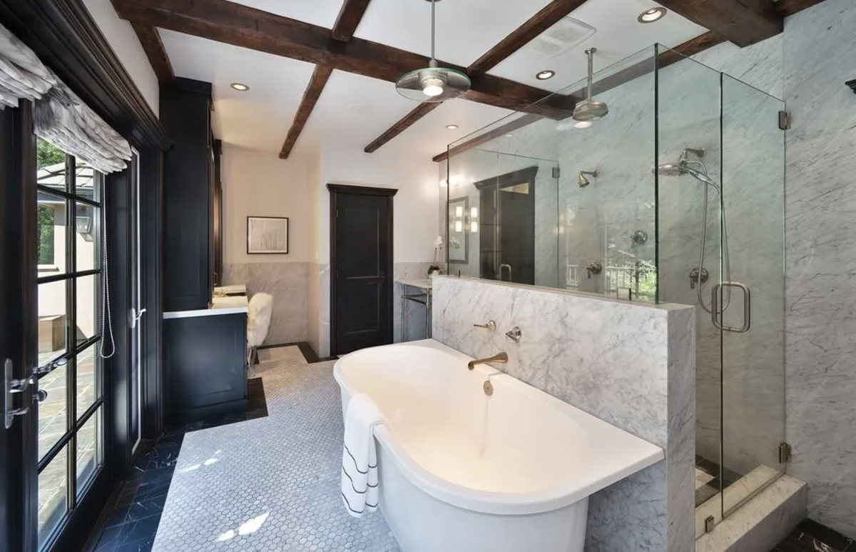 The primary suite’s spa-inspired bathrooms offer indulgent privacy, each with luxe finishes and serene views.
