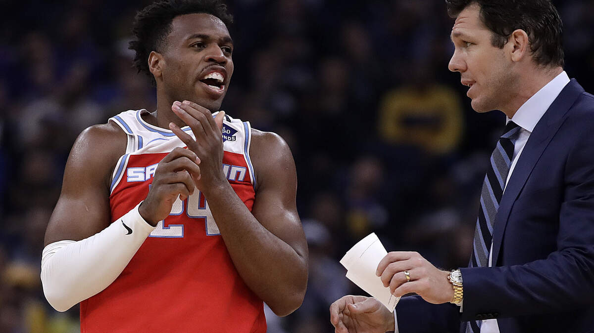 Sacramento Kings’ Buddy Hield, left, speaks with coach Luke Walton during the first half of an NBA basketball game against the Golden State Warriors Tuesday, Feb. 25, 2020, in San Francisco. (AP Photo/Ben Margot)