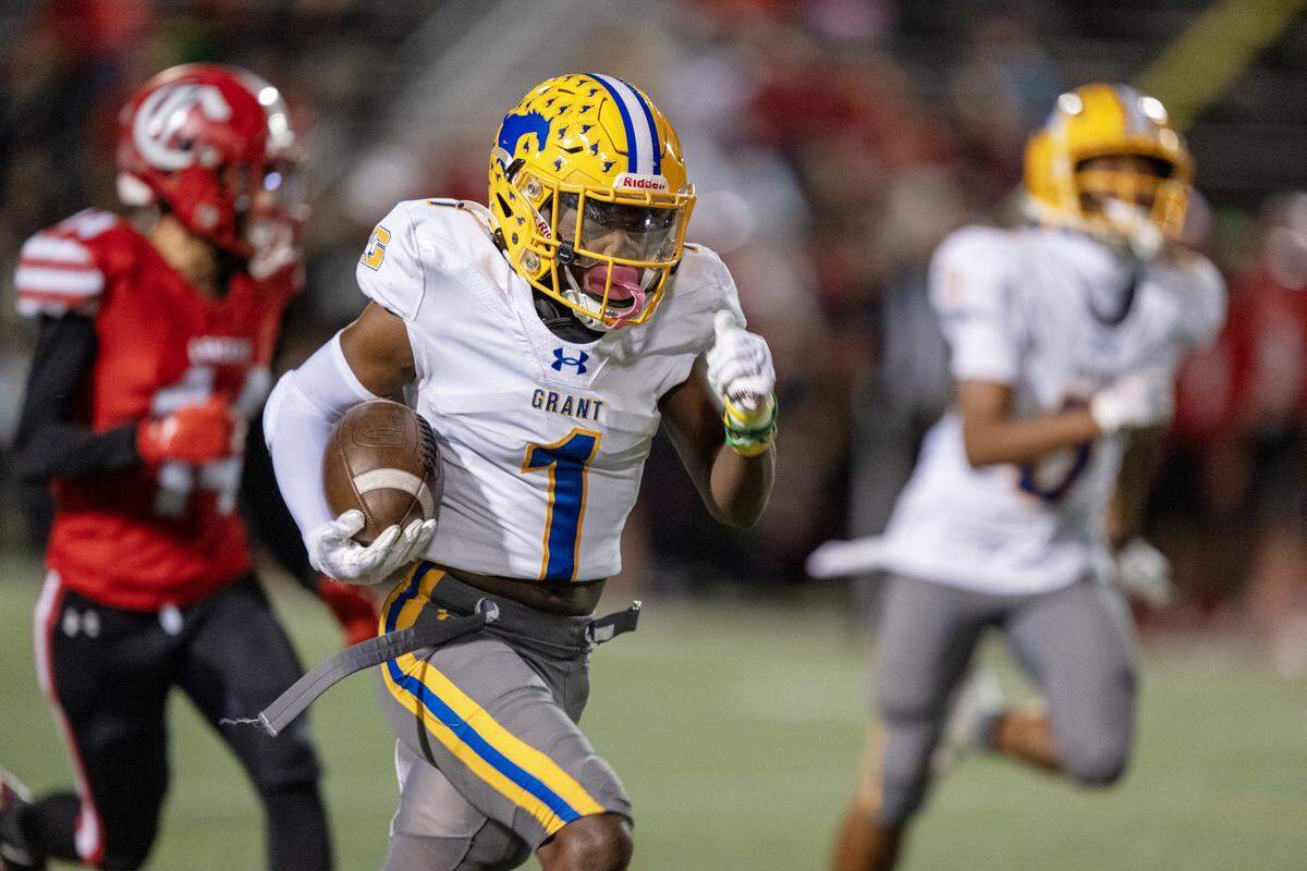 The Grant Pacers' Koby Shabazz (1) takes a screen pass for a touchdown in the first half against the Cordova Lancers in Rancho Cordova in October. 