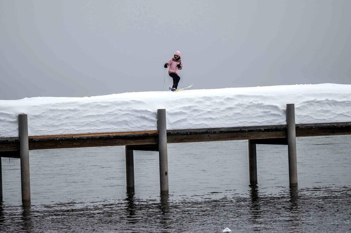 Jerri Johnson of South Lake Tahoe skis on a dock in Lake Tahoe on Monday, March 6, 2023 in El Dorado County.