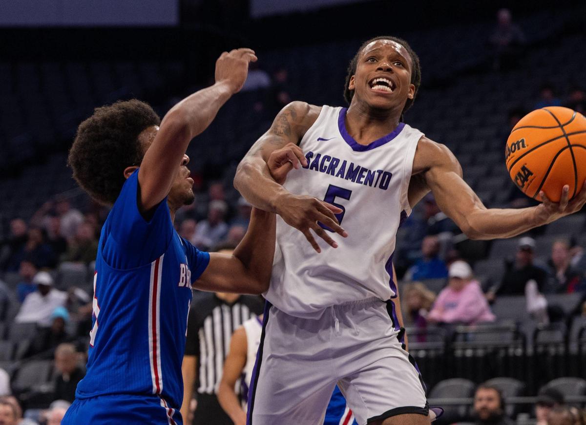 Christian Brothers Falcons’ Stephan Hewitt (13) fouls Sacramento Dragons’ Kendahl Hearne (5) during the CIF Sac-Joaquin Section Division III boys basketball section championship game on Wednesday at Golden 1 Center.