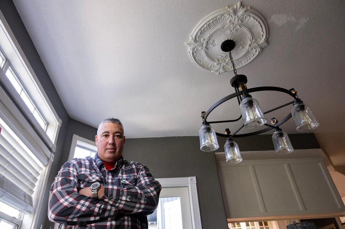 Homeowner Jeff Garcia stands in the breakfast nook in December in Folsom. In 2022, a leak in his master bathroom caused a large water bubble to appear in the downstairs ceiling of the nook.