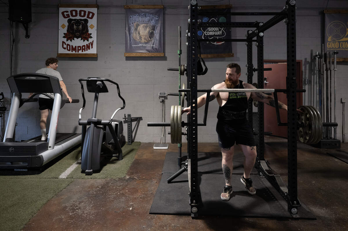 Nick Squires sets up weights during a training session at Third Street Barbell in Sacramento on Wednesday. Squires competed as a member of the Vegan Strong PlantBuilt Team, lifting a combined total of 1,967.4 pounds at a national championship in Tampa, Fla.