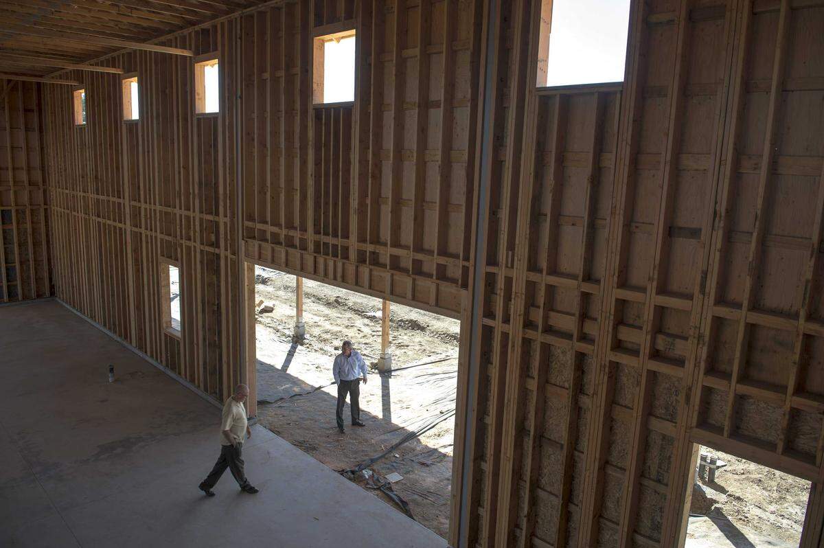 Two men walk through the barn under construction at The Cannery housing project in Davis during construction. The Cannery’s approval in 2013 was controversial, but today Davis faces renewed pressure to approve housing like Village Farms as shrinking school enrollment reflects the city’s declining population of young families.