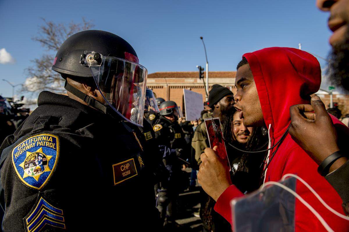 California Highway Patrol Sgt. Ron Wade is berated on March 23, 2018, by angry protesters following the shooting death of Stephon Clark by Sacramento Police officers. 