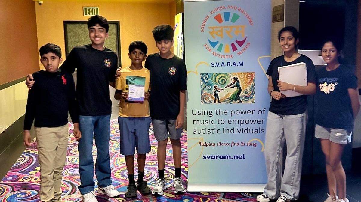 Matthew Paul (second from left), the founder of Sounds, Voices and Rhythms for Autistic Minds (SVARAM), poses with SVARAM board members and event attendees outside of Maya Cinemas in Fresno.