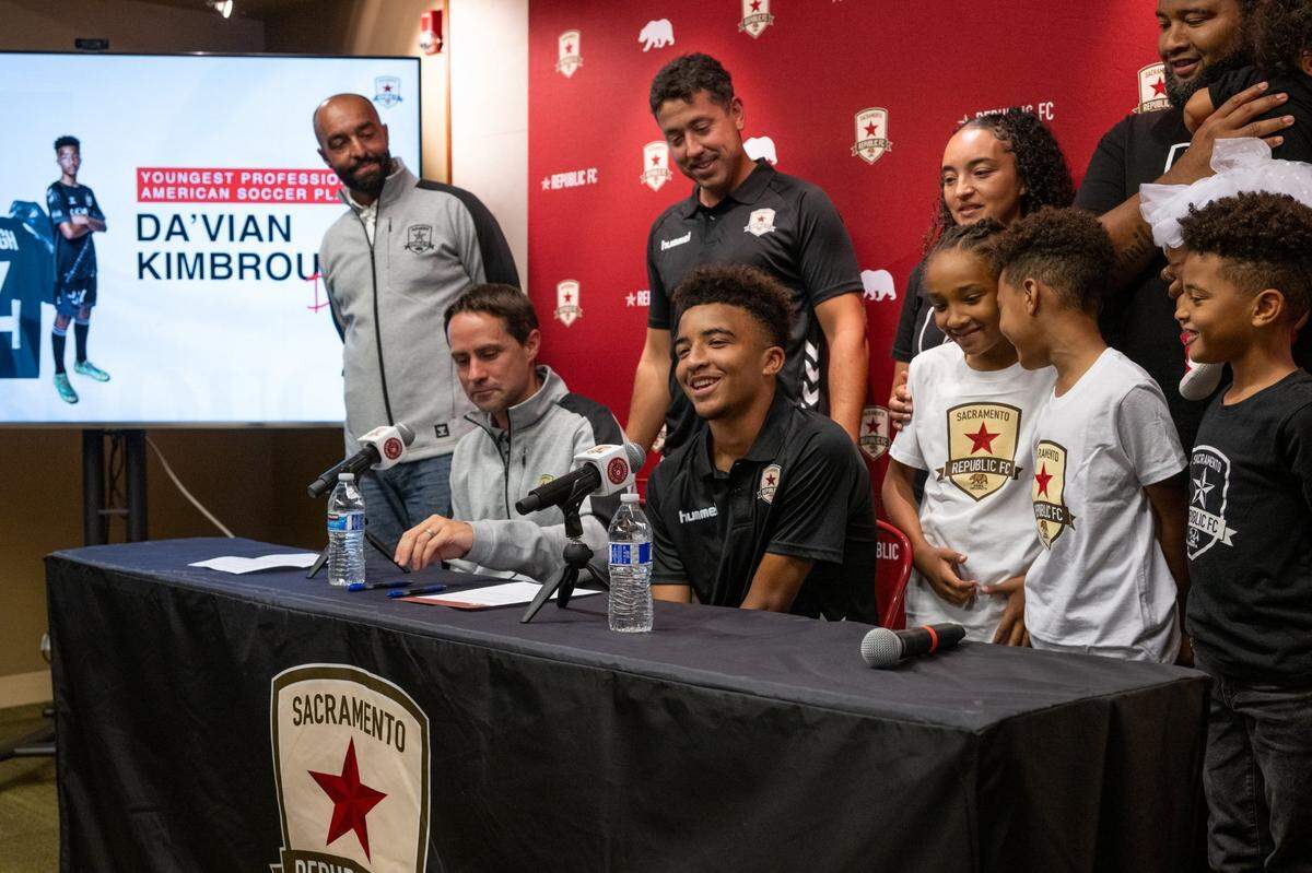 13-year old soccer phenom Da’vian Kimbrough is surrounded by his family and Sacramento Republic FC management after signing a contract Tuesday, making him the youngest professional athlete in American sports history.