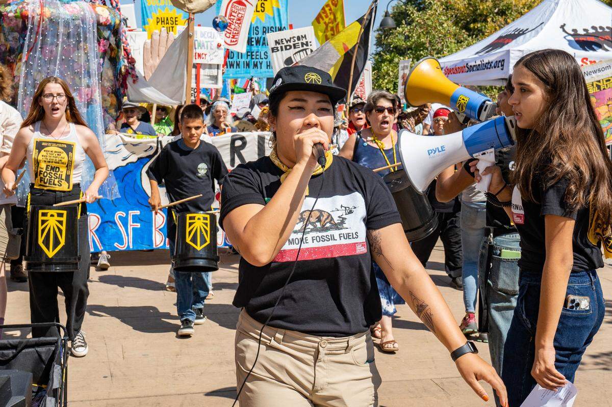 Megan Nguyen of the Oil and Gas Action Network leads a Sacramento protest to end fossil fuels on Sunday.