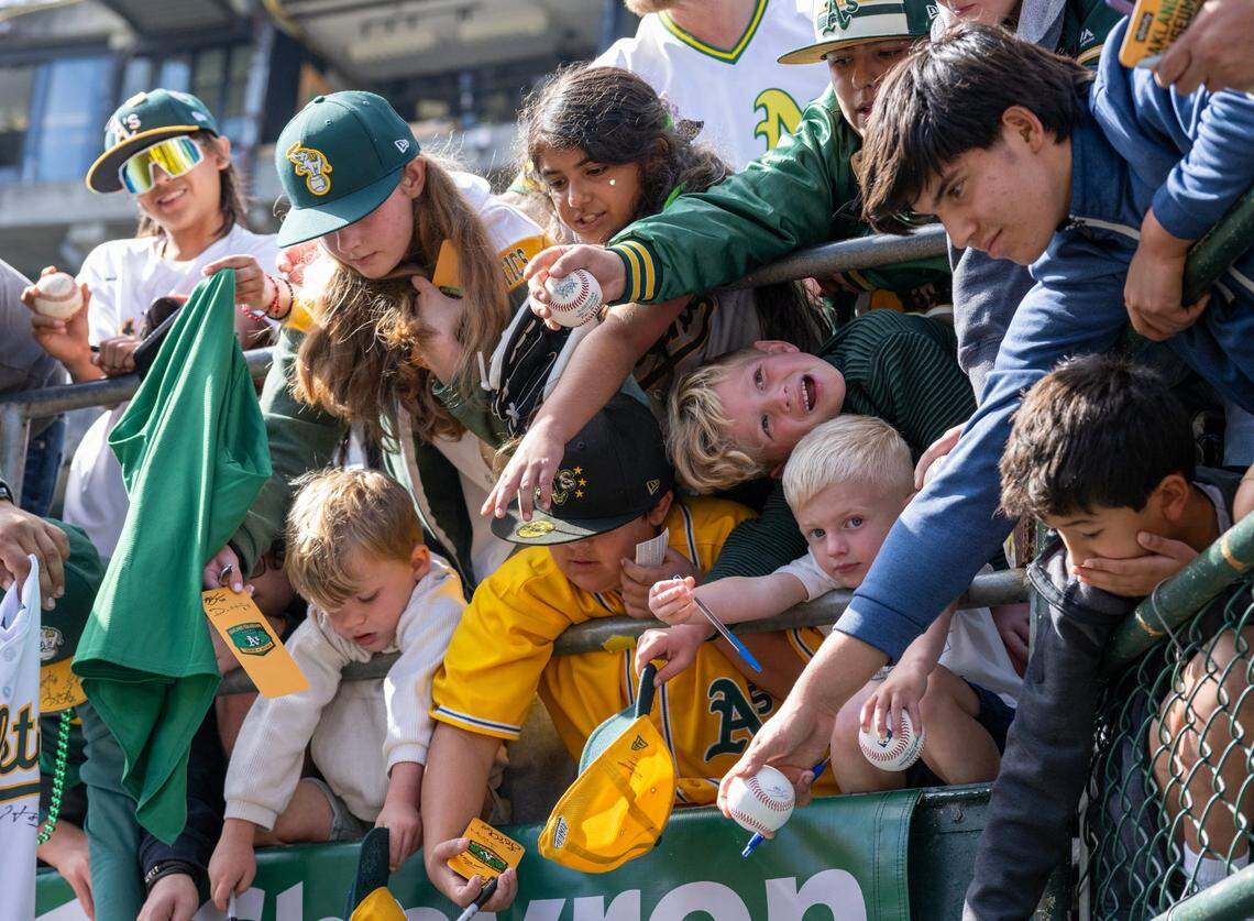 The Oakland A’s fans wait for autographs before the final home game at Oakland-Alameda County Coliseum on Thursday.
