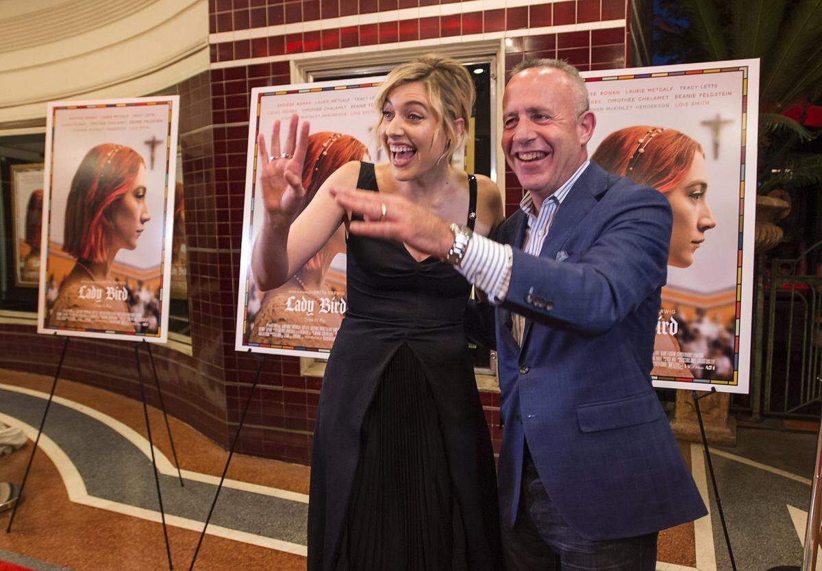 Sacramento film actor and director Greta Gerwig waves to fans with Mayor Darrell Steinberg as she walks down the red carpet for the premier of her film “Lady Bird” at the Tower Theatre in Sacramento on Oct. 29, 2017.