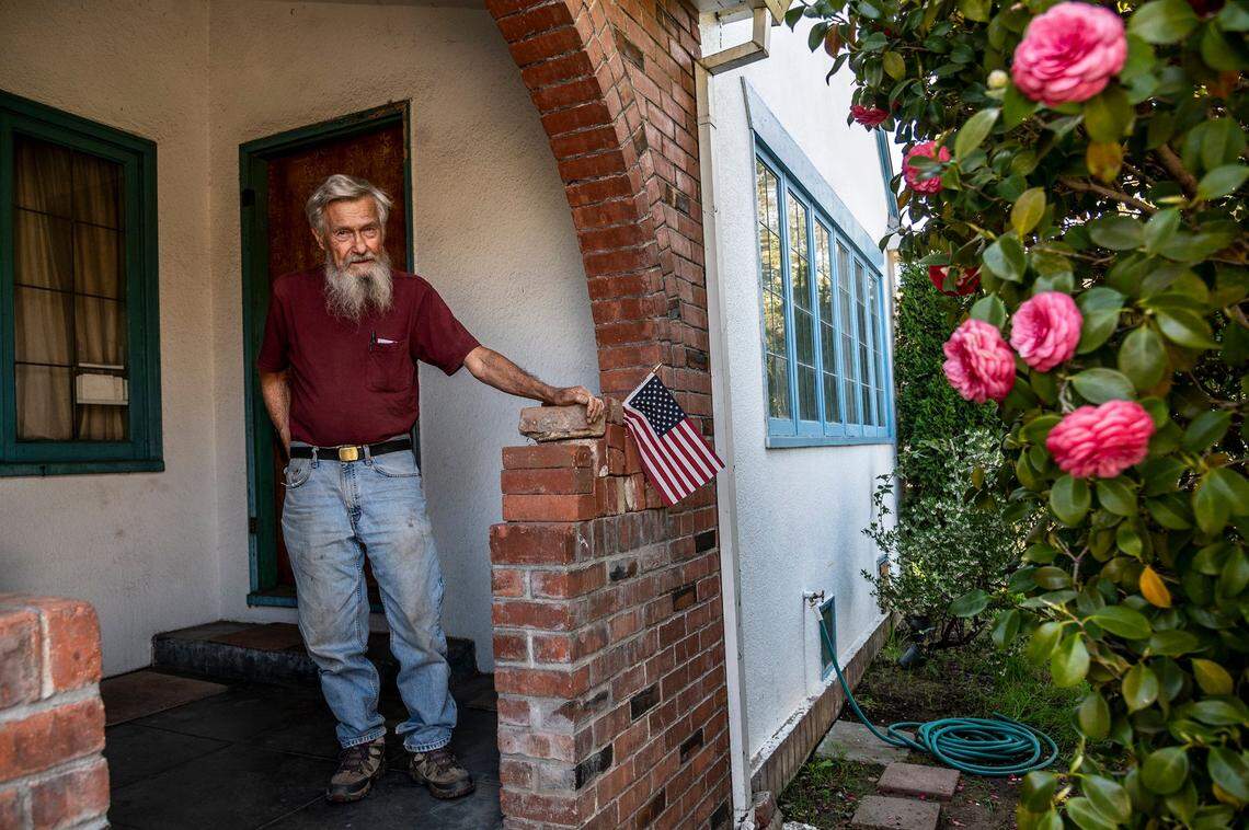 Dan Altstatt, 83, stands on his front porch in East Sacramento on March 14. He is facing $573,000 in fees from the city for minor code violations and said he is worried about losing the home he inherited from his parents in 1982. He said he’s on a fixed income of $1,000 a month and doesn’t collect any Social Security.