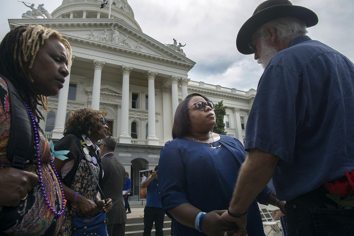 Dr. Nicole Clavo, center, greets several supporters during a rally sponsored by Victims Rights United of California on the west steps of the state Capitol in Sacramento on Thursday, April 7, 2016. In November of 2015 Clavo’s son - J.J. Clavo - was shot and killed on his way to a football game at Grant High School in Sacramento.