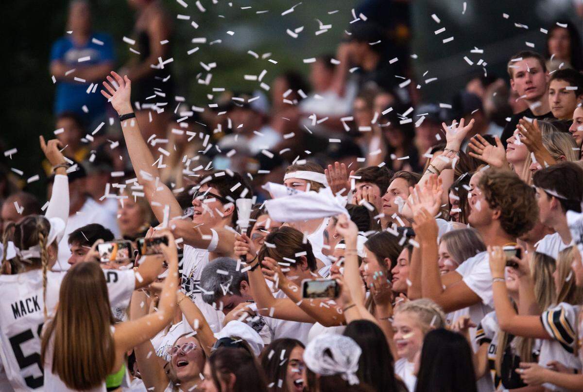 The “Black Hole,” Del Oro’s student cheering section, throws confetti as their team leads Del Campo at an August football game. Parent volunteers can show proof of COVID-19 vaccination or a negative PCR test to assist with activities on campus.