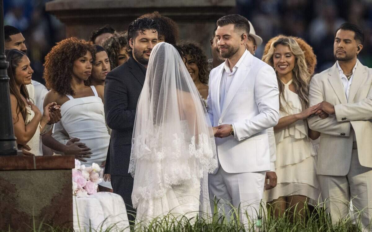 Antonio Reyes, a campus pastor in Sacramento, officiates a wedding during Bad Bunny’s Super Bowl halftime show at Levi’s Stadium on Sunday.