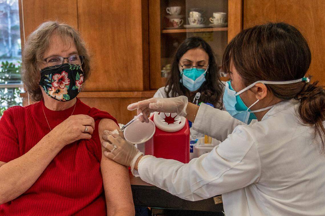 Pioneer House resident Cindy Mallory, 72, receives the COVID-19 vaccine from CVS pharmacist Ngun Le in Sacramento on Jan. 5, 2021. As part of California’s equitable approach to COVID-19 vaccine distribution, nursing home residents and staff are receiving inoculations this week through a government partnership with CVS and Walgreens. Mallory said she remembers her mother taking her and her siblings to get the polio vaccine when she was a small child. “People were hesitant to get that too because it was new,” she said. “Well this is new. Give it to me now, please!”
