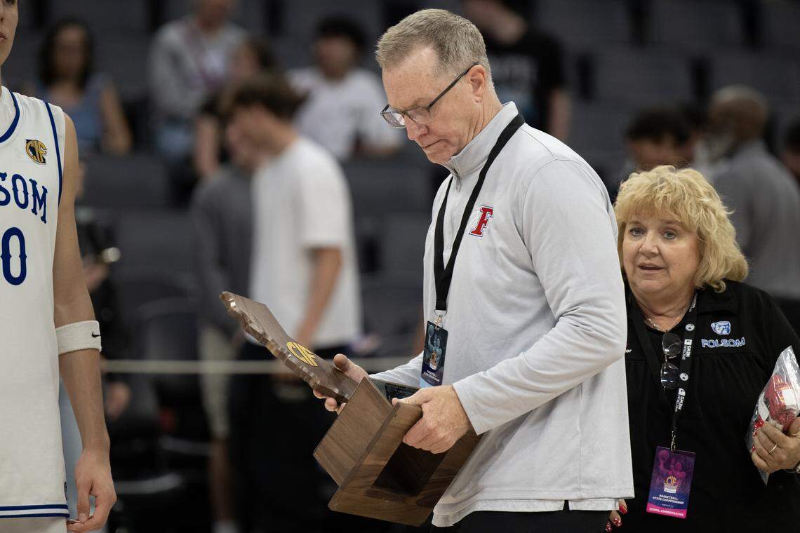Folsom Bulldogs coach Mike Wall looks at the second place trophy following the 58-55 loss to the Damien Spartans the CIF State Division I boys basketball championship Friday at Golden 1 Center.