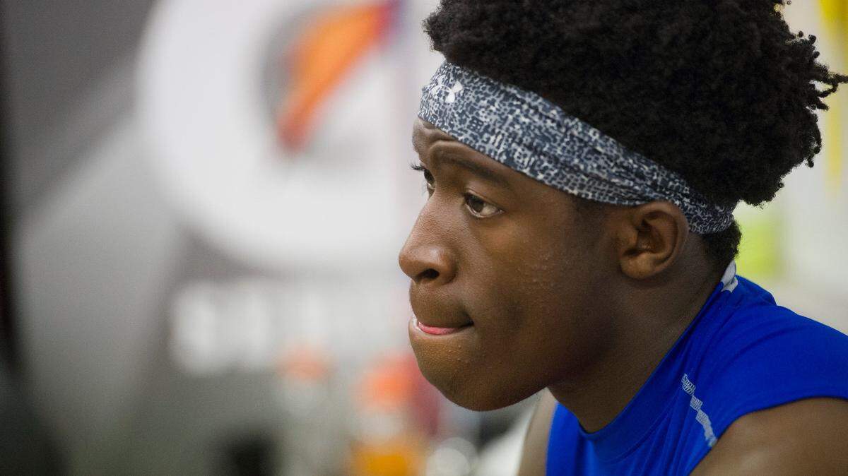 Folsom receiver Joe Ngata gets ready inside the locker room before the Bulldogs hosted the Central High School Grizzlies in the CIF NorCal Division I-AA title game on Dec. 8, 2017.