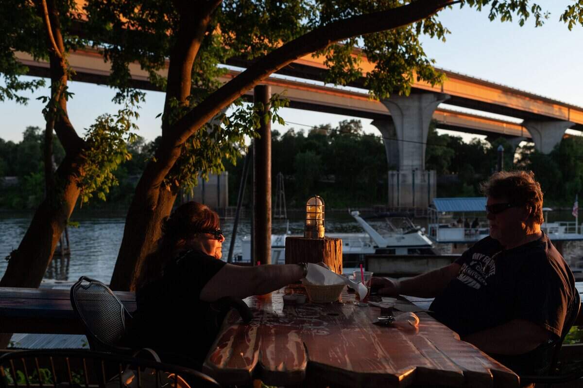 Kay, left, and Cecil Irvan, of Elk Grove, share food while dining outside along the Sacramento River at Swabbies On The River Restaurant & Bar in 2020.