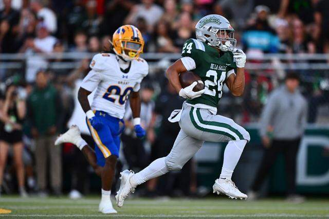 De La Salle’s Duece Jones-Drew (24) runs for a 64-yard touchdown past Grant’s Ezekiel Castex (20) in the first quarter of their game at De La Salle High School in Concord on Friday, Aug. 30, 2024. The teams will play again this season, on Sept. 19, at Grant in Del Paso Heights.