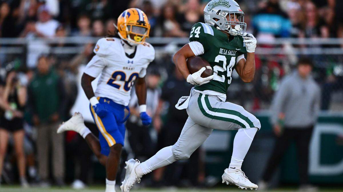 De La Salle’s Duece Jones-Drew (24) runs for a 64-yard touchdown past the Grant Pacers’ Ezekiel Castex (20) in the first quarter of their game at De La Salle High School in Concord on Friday.