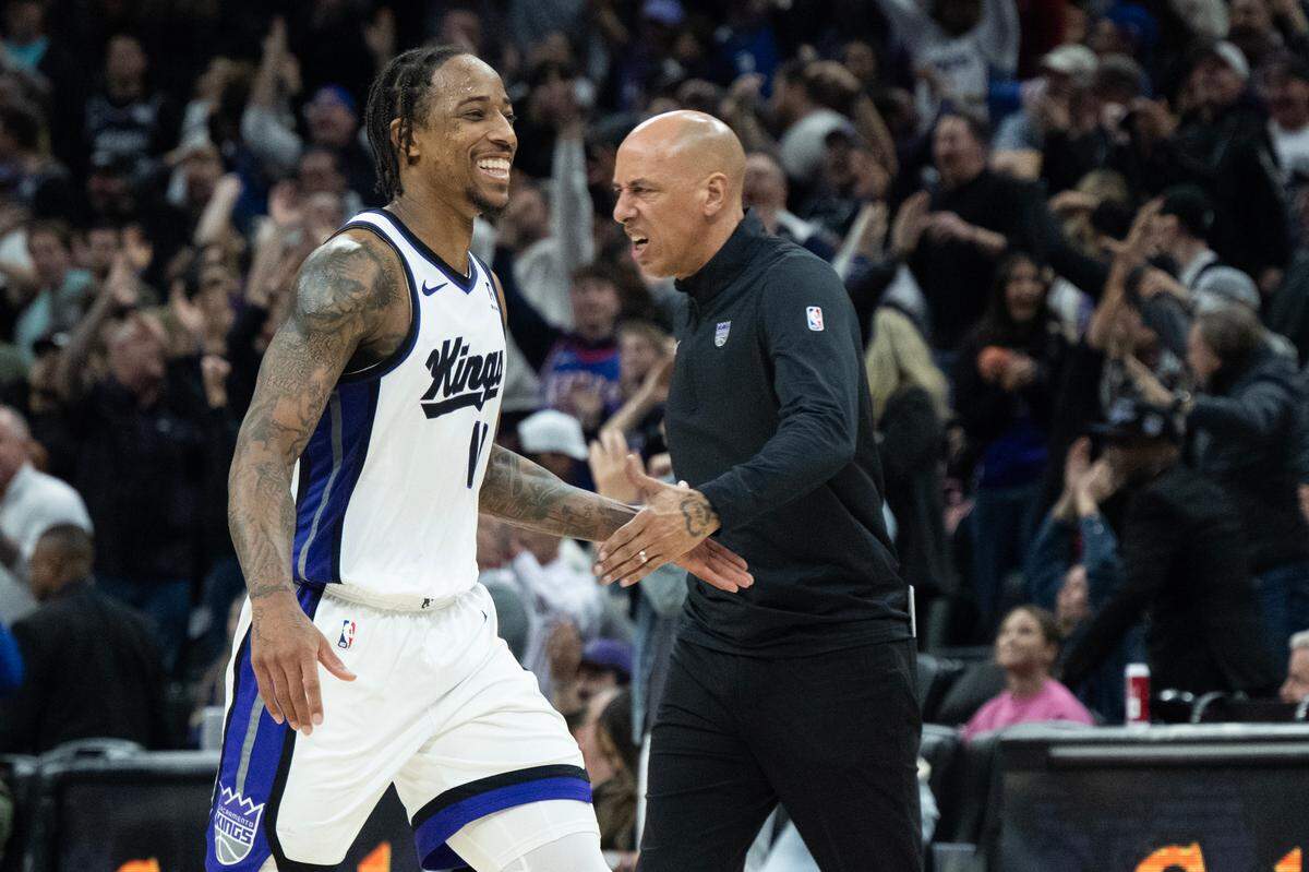 Sacramento Kings forward DeMar DeRozan (10) celebrates with interim head coach Doug Christie after a 3-point basket over Miami Heat guard Tyler Herro (14) in double overtime to end the game at Golden 1 Center on Monday, Jan. 6, 2025.