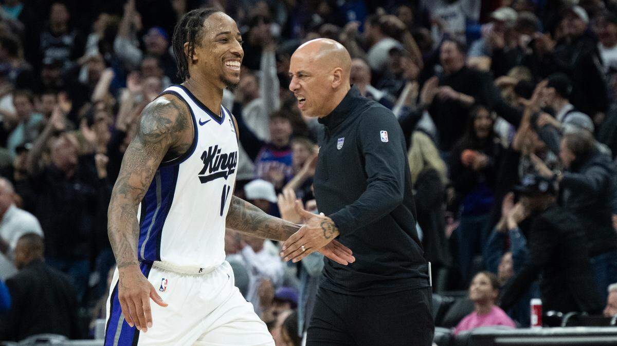 Sacramento Kings forward DeMar DeRozan (10) celebrates with interim head coach Doug Christie after a 3-point basket over Miami Heat guard Tyler Herro (14) in double overtime to end the game at Golden 1 Center on Monday.
