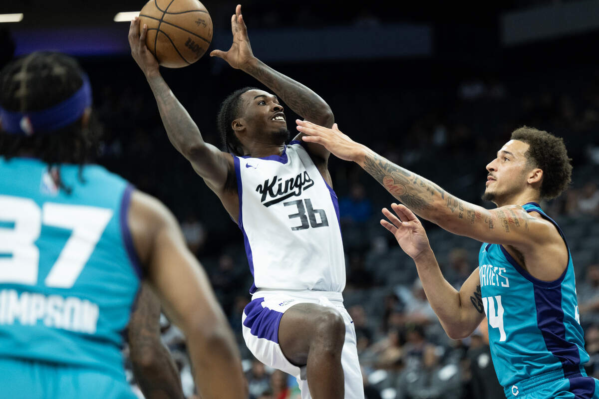 Sacramento Kings guard Antoine Davis shoots over the Charlotte Hornets’ Caleb McConnell during a California Classic summer league game Tuesday at Golden 1 Center.