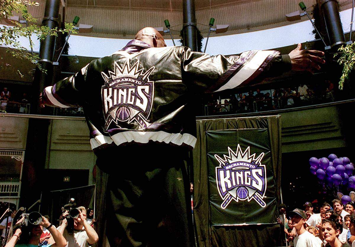 Olden Polynice of the Sacramento Kings models a leather outfit with the new team logo at the logo unveiling at Downtown Plaza on Sunday, May 22, 1994.