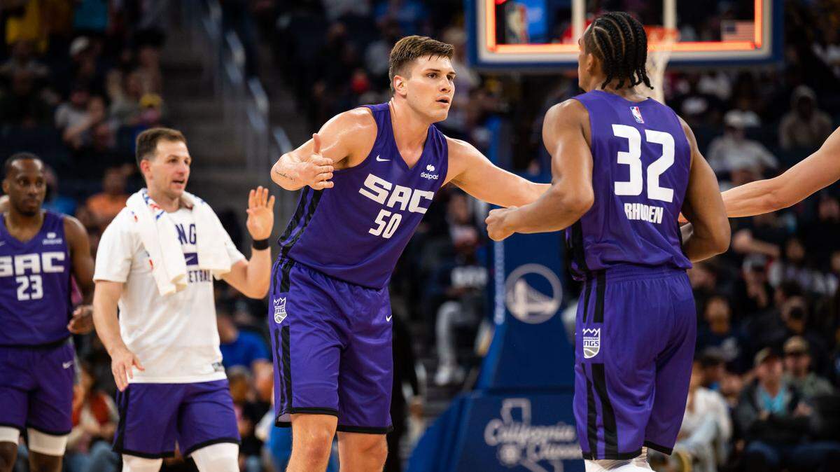 Sacramento Kings center Nate Sestina (50), center, cheers teammate forward Jared Rhoden (32) and others during a timeout while playing the Golden State Warriors at the California Classic NBA preseason basketball game Saturday, July 2, 2022, at Chase Center in San Francisco.