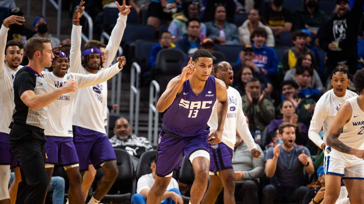 Sacramento Kings forward Keegan Murray (13) is cheered by teammates and fans after sinking the first three point basket — and his first score for the Kings — in the early moments of the first period against the Golden State Warriors during the California Classic NBA preseason basketball game Saturday, July 2, 2022, at Chase Center in San Francisco.