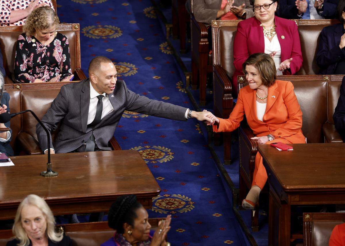 House Minority Leader Hakeem Jeffries, D-N.Y., holds hands with Rep. Nancy Pelosi , D-Calif., as the House of Representatives holds a second round of voting for a new Speaker on Oct. 18, 2023. The House has been without an elected leader since Rep. Kevin McCarthy, R-Calif., was ousted from the speakership in a move led by a small group of conservative members of his own party. Jeffries succeeded Pelosi as the leader of the Democrats in the chamber. 