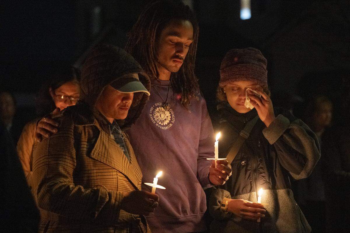 Allisha Crockett, Malachi Little, and Olanii Crockett pray during a vigil on Mill Water Circle in Rancho Cordova on Sunday held to remember the Vallerga family who were found dead in their home on the street on Jan. 27 in an apparent murder-suicide.