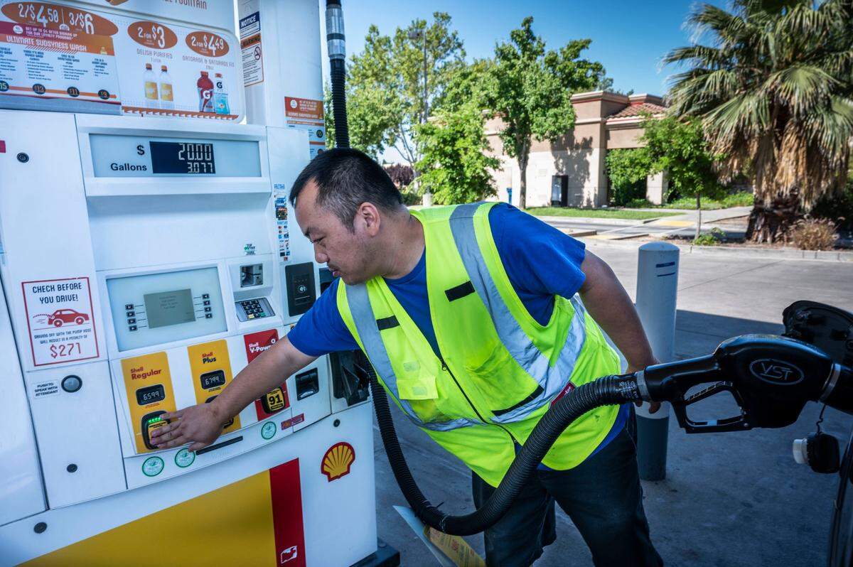 Sacramento resident Jay Lor pumps gas on Monday, June 13, 2022 at the Shell station on Del Paso Road in Natomas.