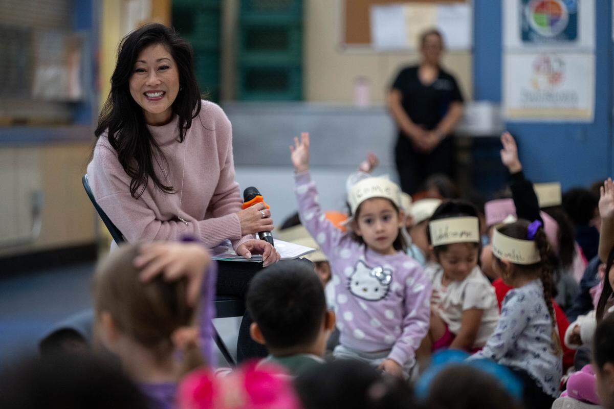 Olympic gold medalist figure skater Kristi Yamaguchi listens to a question from a student after reading from her book “Cara’s Kindness” at Hazel Strauch Elementary School in Sacramento on Monday.