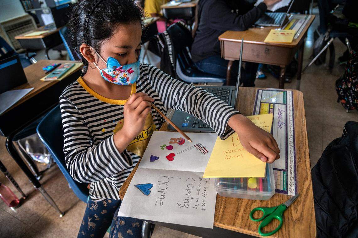 Imani Emos, 9, included an American flag in her card as she joined other classmates on Oct. 22 to craft welcome home messages for Afghan classmates who recently escaped Taliban rule and were safe in the United Arab Emirates.