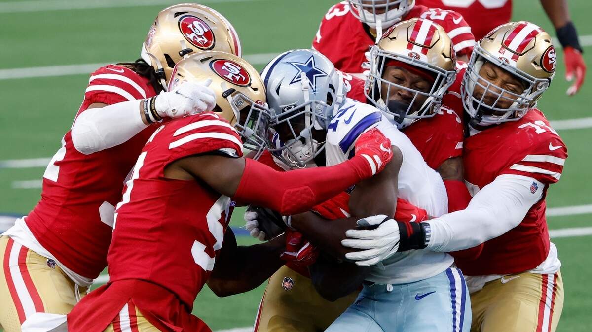 Dallas receiver Michael Gallup, center, is wrapped up by the San Francisco defense Sunday.