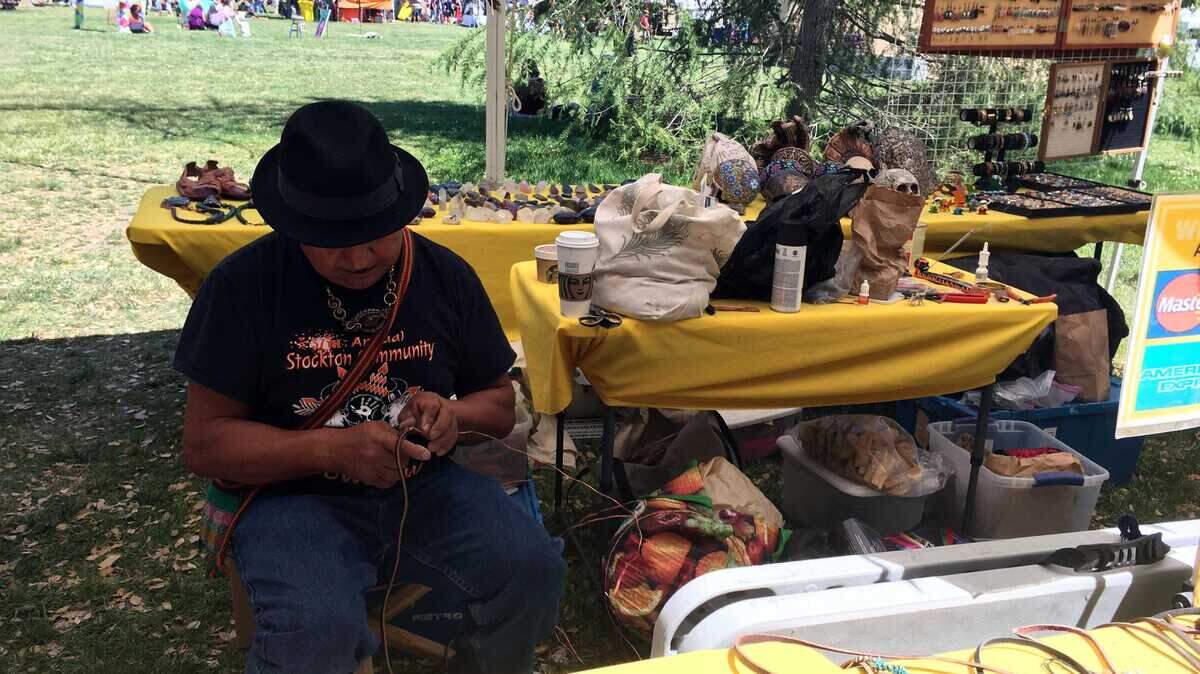Jesus Vasquez, a vendor at the UC Davis Whole Earth Festival, works on a piece of leather. He and his wife, Soledad Munoz, sold handcrafted leather pieces, wire wrapped crystals and dream catchers at the event.