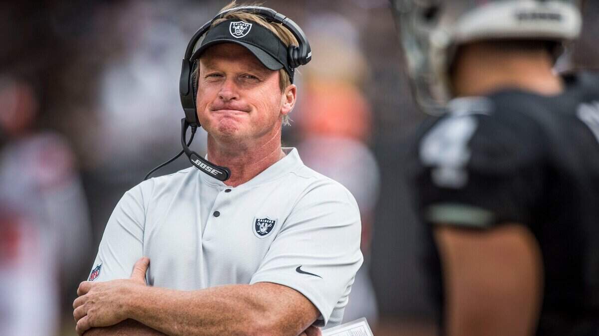 Raiders coach Jon Gruden looks at quarterback Derek Carr (4) as they talk following a turnover against the Cleveland Browns at the Coliseum in Oakland on Sept. 30, 2018.