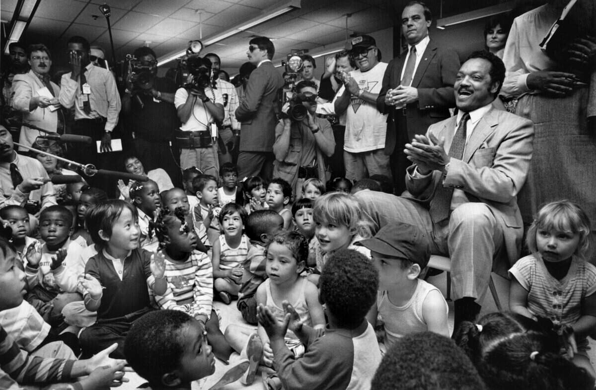 The Rev. Jesse Jackson visits the Del Paso Early Childhood Education Center in Sacramento on May 23, 1988, where he led students in chants that included "I am somebody," "Down with dope, up with hope" and "Jackson action."