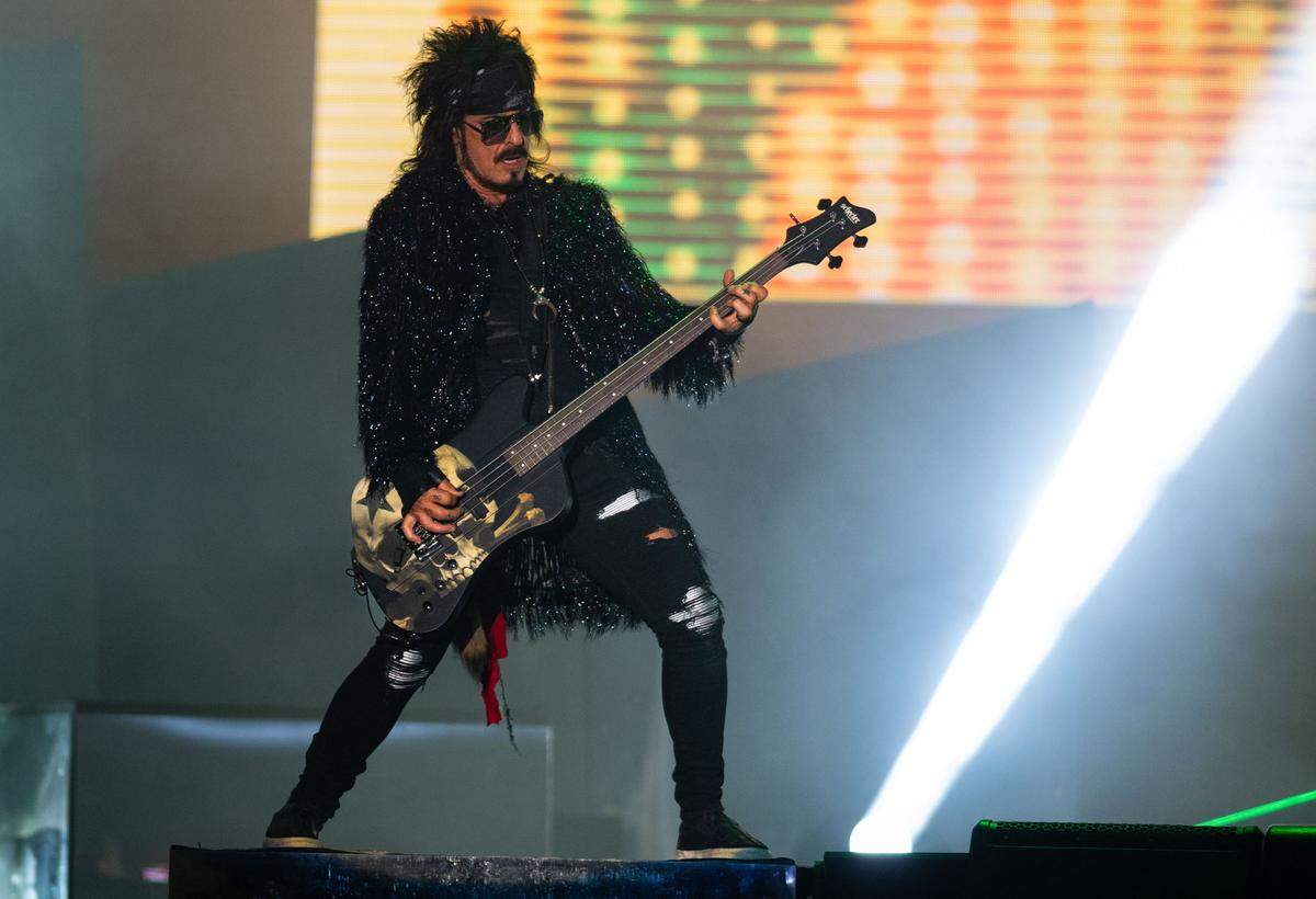 Motley Crue bassist Nikki Sixx strums with the band to close out the Aftershock festival in Sacramento’s Discovery Park on Sunday.