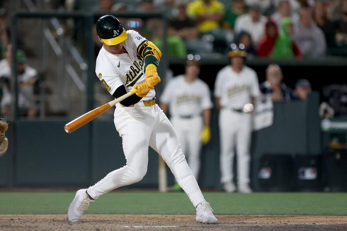 May 24, 2025; West Sacramento, California, USA; Athletics designated hitter Brent Rooker (25) hits a solo home run against the Philadelphia Phillies during the eighth inning at Sutter Health Park. Mandatory Credit: Dennis Lee-Imagn Images