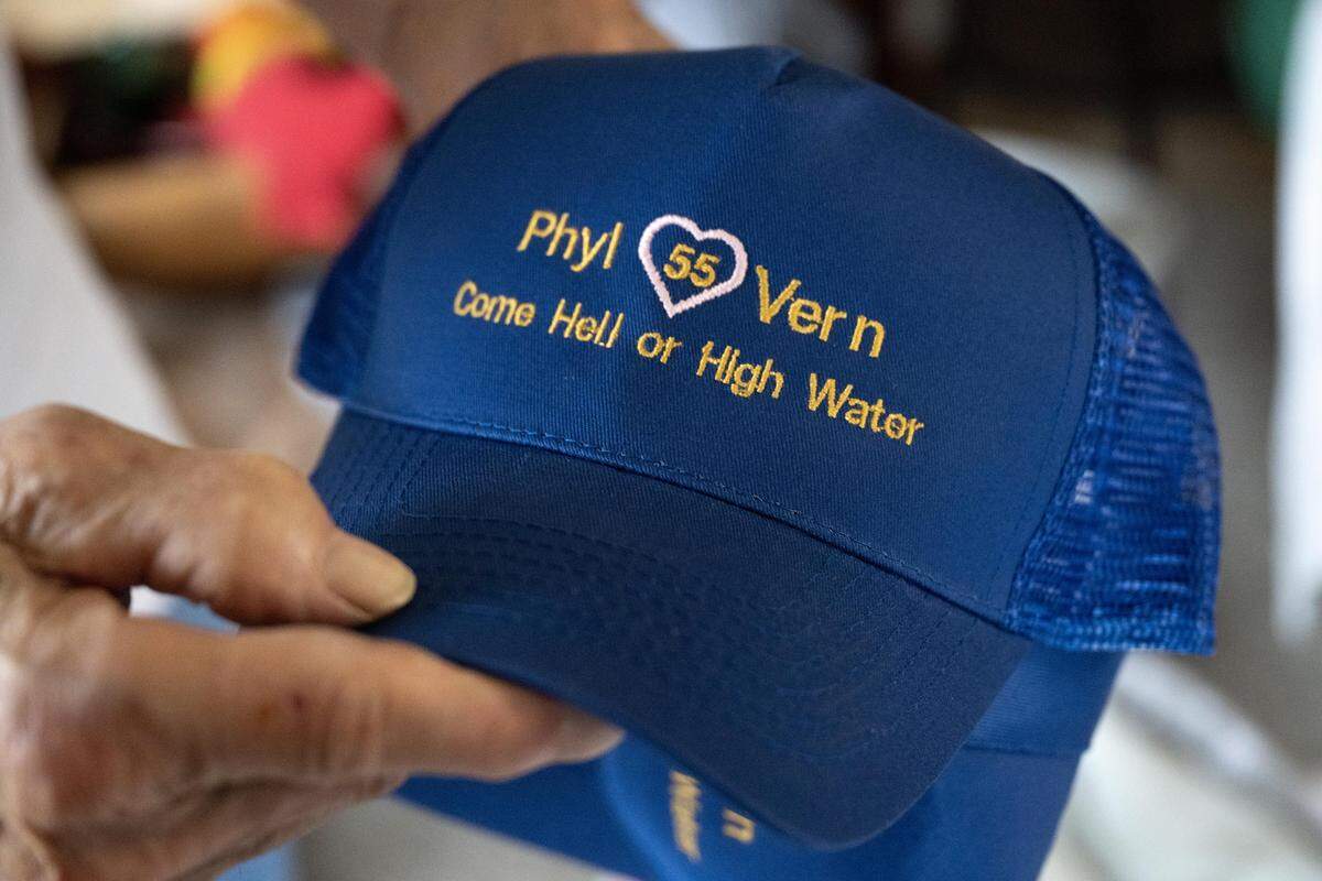 Vern Hill holds a hat that was given to him and his wife, Phyllis, for their anniversary as he stands in his Yuba City home. The couple married only days before the historic flood in Yuba City in 1955.