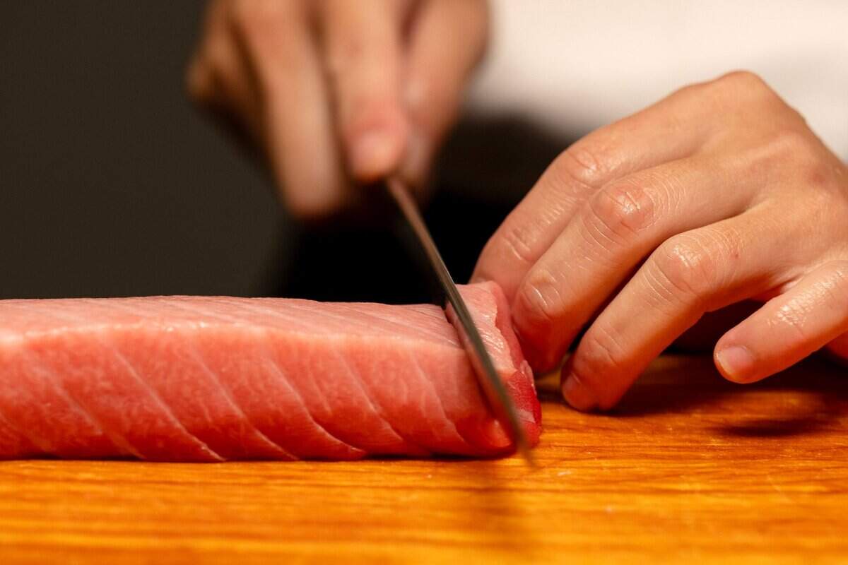 Chef Frank Zhu slices tuna imported from Japan at Chef Frank Japanese Cuisine in North Natomas last month.