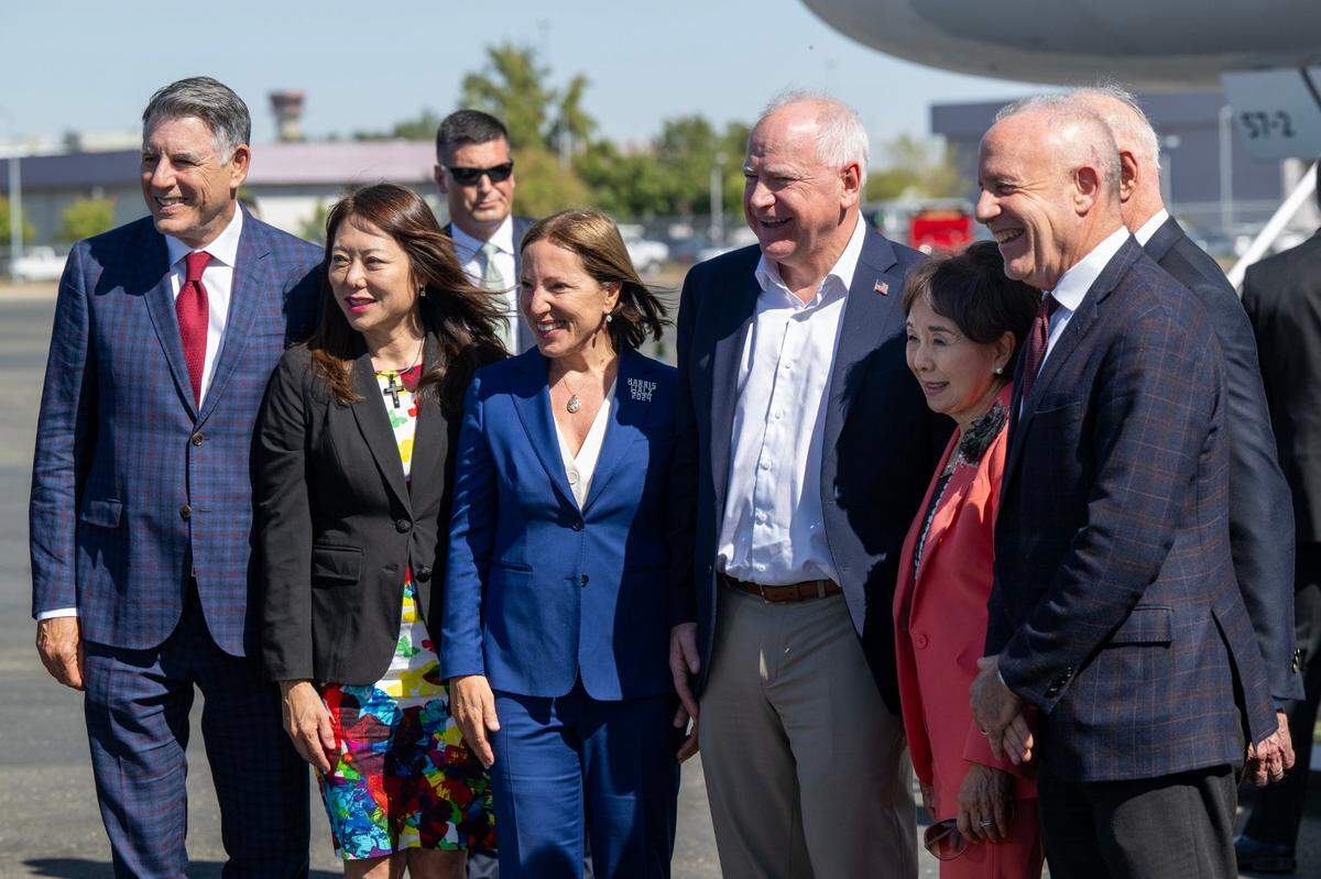 Democratic vice presidential candidate Tim Walz, governor of Minnesota, poses for a photo with, from left, California “second partner” Markos Kounalakis, California Treasurer Fiona Ma, Lt. Gov. Eleni Kounalakis, U.S. Rep. Doris Matsui and her husband Roger Sant (obscured), and Sacramento Mayor Darrell Steinberg during a fundraising stop at Sacramento International Airport on Tuesday, Oct. 8, 2024.