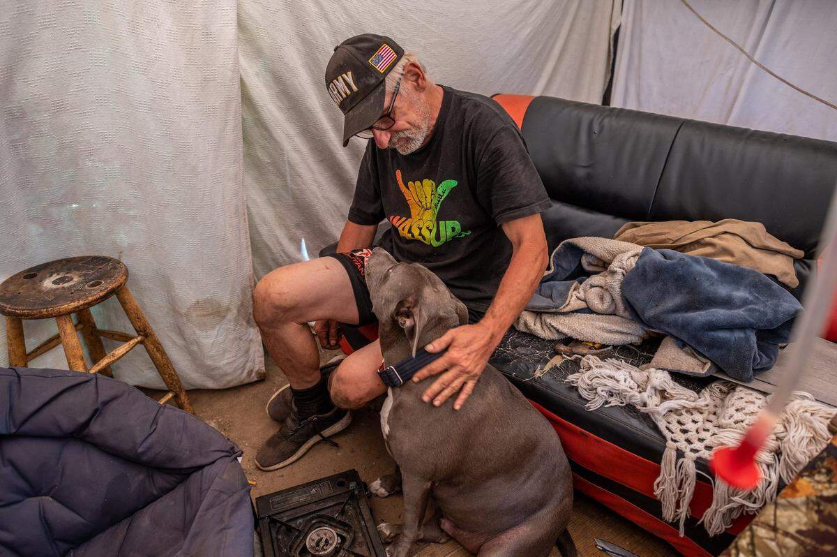 Carl White said that he could never move without his dog Buddy. He said he has been homeless for about two and a half years. When his seasonal job working as a painter ended, he could no longer afford rent.